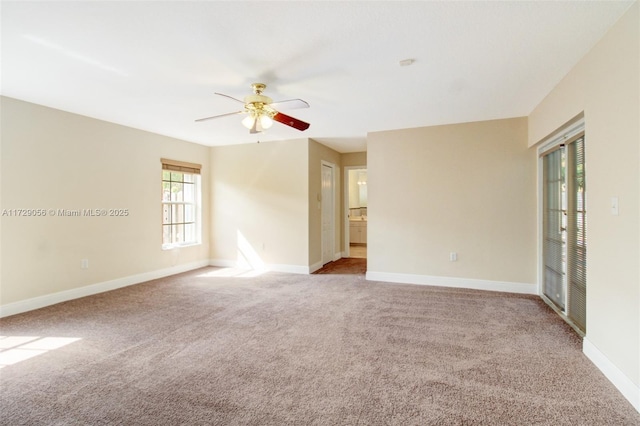 spare room featuring carpet flooring, ceiling fan, and baseboards