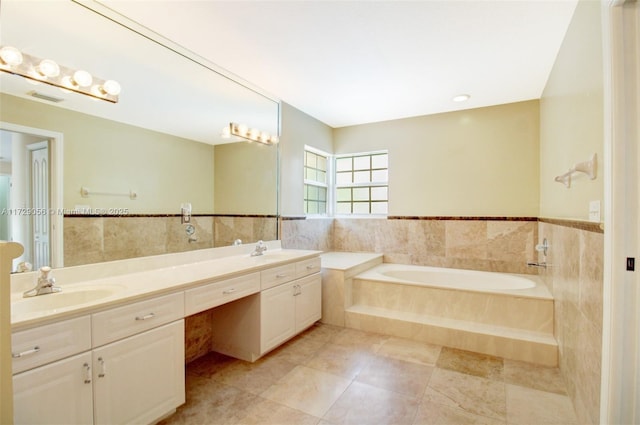 bathroom featuring tile patterned floors, a garden tub, double vanity, and tile walls