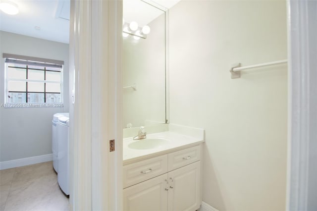 bathroom featuring tile patterned flooring, baseboards, and vanity