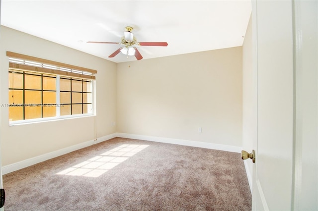 spare room with ceiling fan, carpet flooring, and baseboards