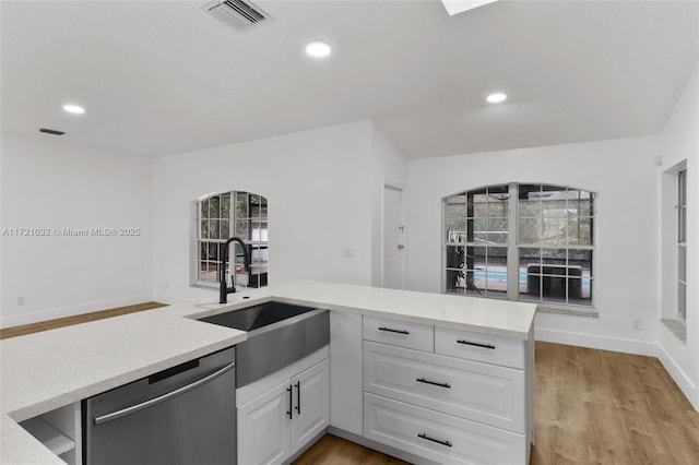 kitchen featuring light hardwood / wood-style floors, sink, white cabinets, and dishwasher