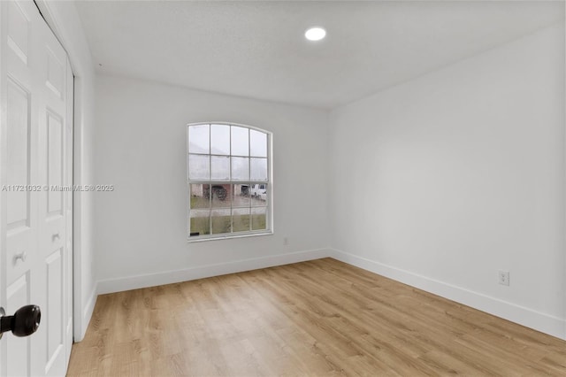 unfurnished bedroom featuring light wood-type flooring and a closet