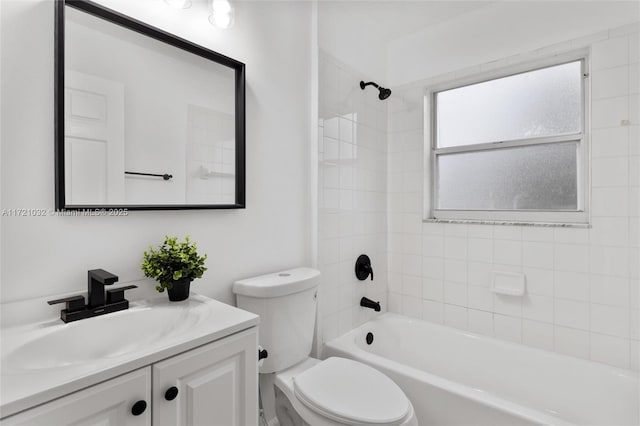 full bathroom with tiled shower / bath combo, toilet, and vanity