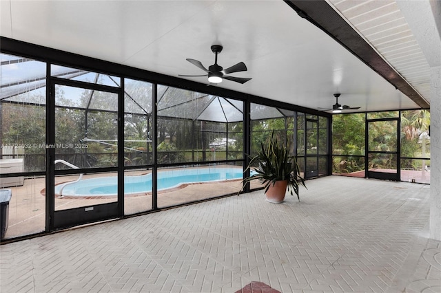 unfurnished sunroom featuring ceiling fan