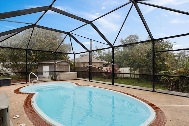 view of swimming pool with glass enclosure, a shed, and a patio area