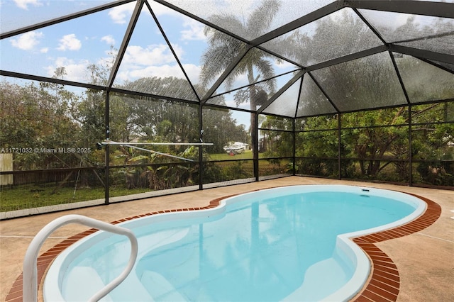 view of swimming pool featuring a patio and a lanai