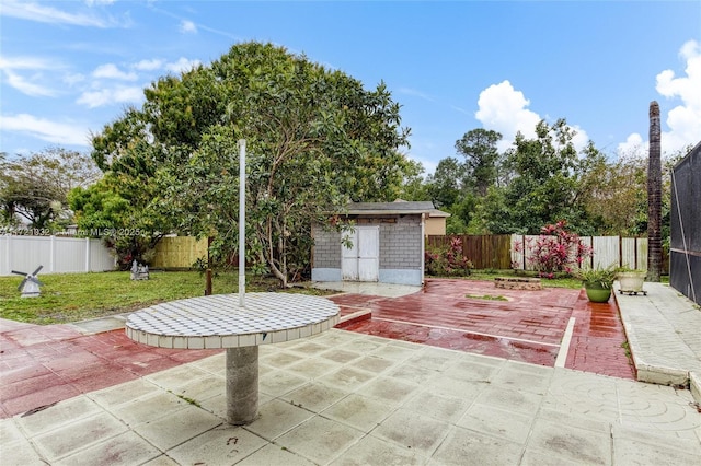 view of patio featuring a storage unit