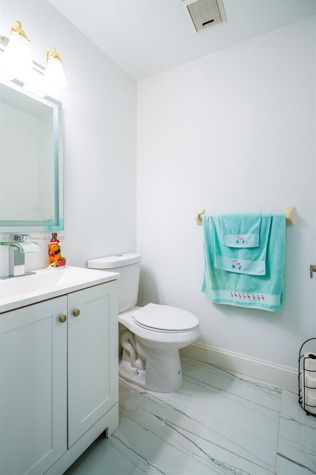 bathroom featuring toilet and vanity