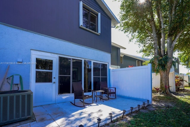 back of property featuring cooling unit and a patio