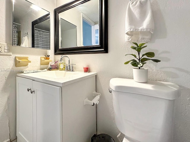 bathroom with toilet and vanity