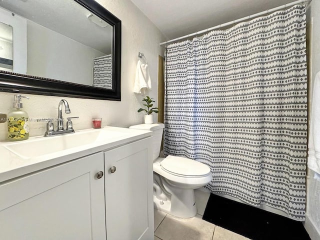 bathroom featuring vanity, toilet, a shower with shower curtain, and tile patterned flooring