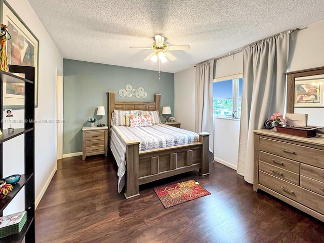 bedroom featuring ceiling fan, a textured ceiling, and dark hardwood / wood-style flooring