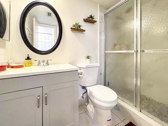 bathroom featuring vanity, toilet, an enclosed shower, and tile patterned flooring