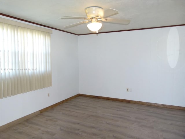 unfurnished room featuring crown molding, hardwood / wood-style floors, and ceiling fan