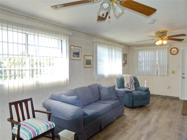 living room with hardwood / wood-style flooring and ceiling fan