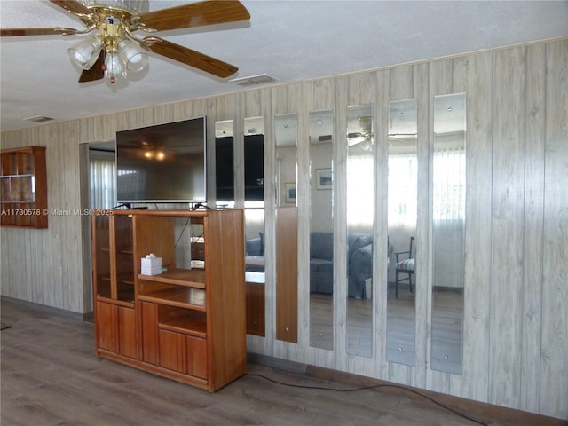 interior space with wood-type flooring and ceiling fan