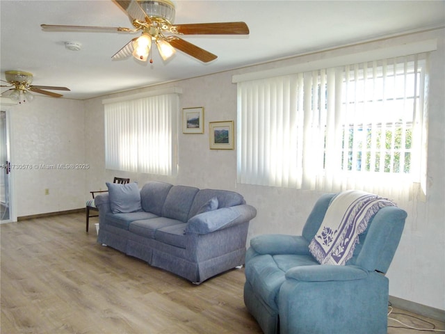 living room with ceiling fan, light hardwood / wood-style flooring, and a wealth of natural light