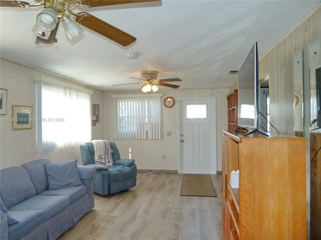 living room featuring ceiling fan and light wood-type flooring