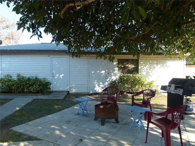 view of patio featuring a grill and a fire pit