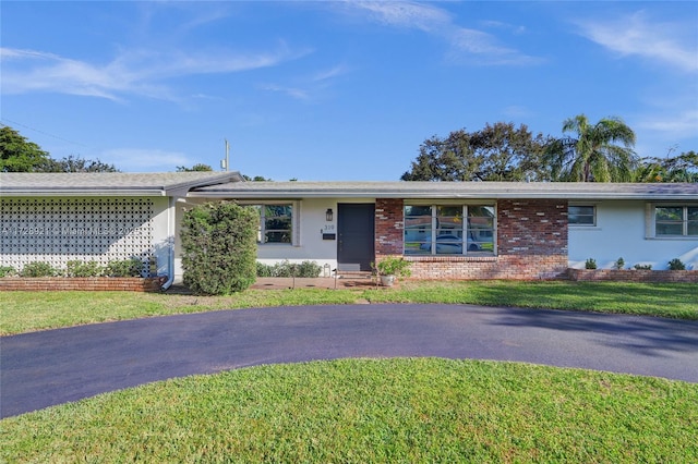 ranch-style home with a front lawn