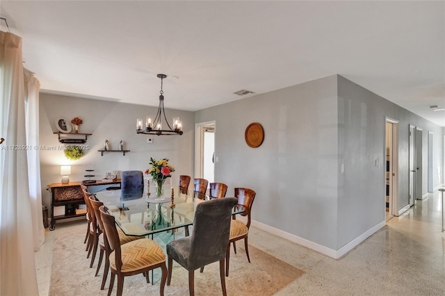 dining space featuring a notable chandelier