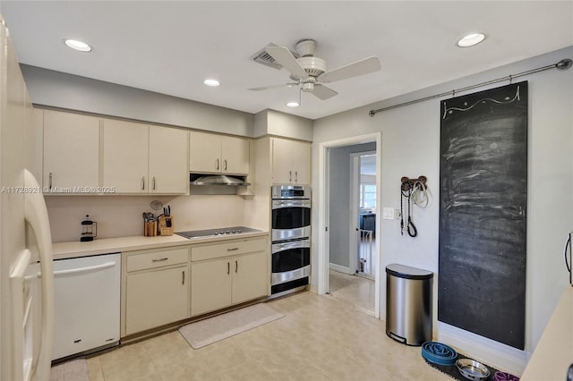 kitchen with black cooktop, dishwasher, ceiling fan, stainless steel double oven, and cream cabinetry