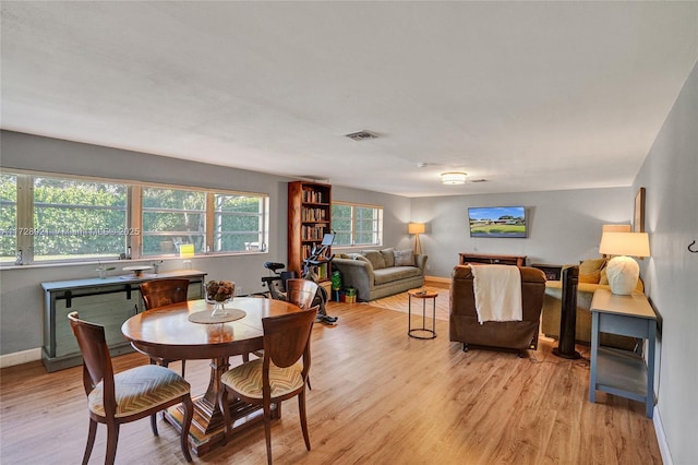 dining area featuring light wood-type flooring