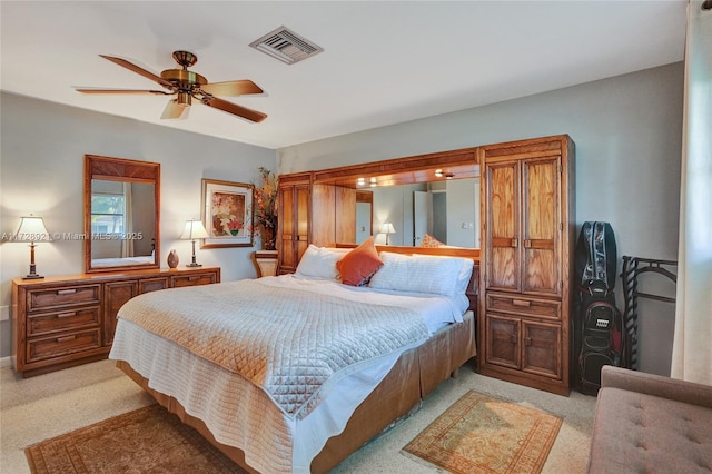 bedroom featuring light colored carpet and ceiling fan