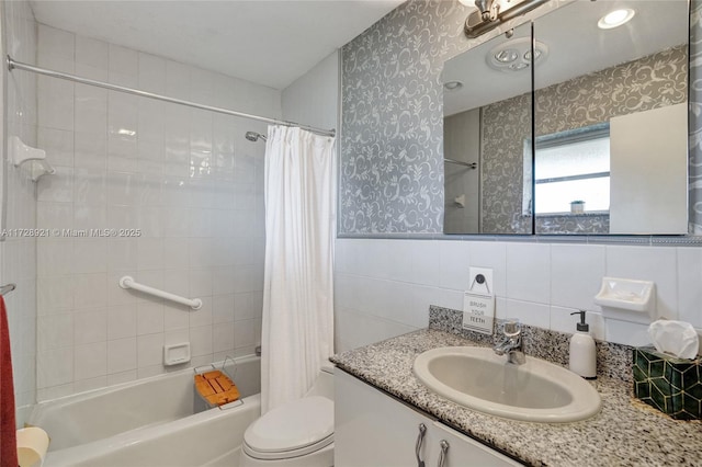 full bathroom featuring vanity, tile walls, shower / tub combo with curtain, and toilet