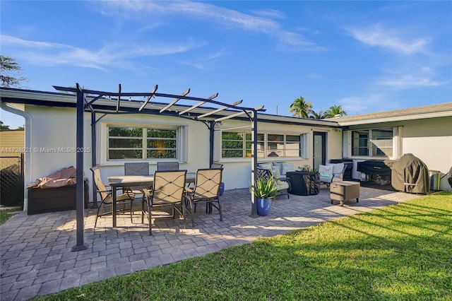 back of property with a pergola, a patio area, and a lawn