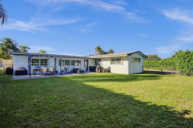 back of house featuring a patio area and a lawn