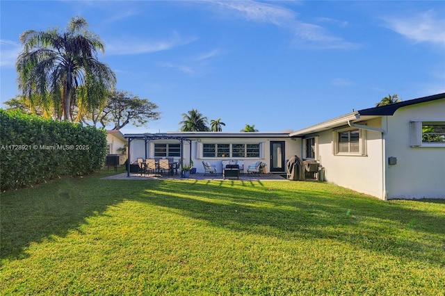 back of property featuring a patio, a yard, and a pergola