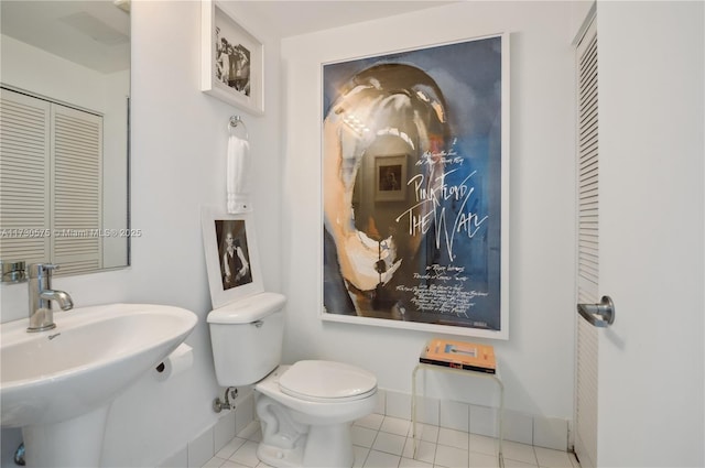 bathroom featuring tile patterned flooring, sink, and toilet