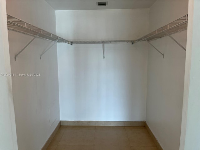 walk in closet featuring tile patterned flooring