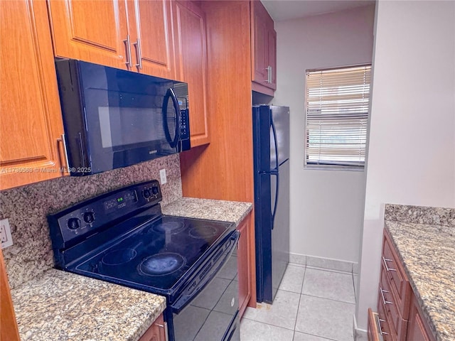 kitchen featuring black appliances and light tile patterned floors