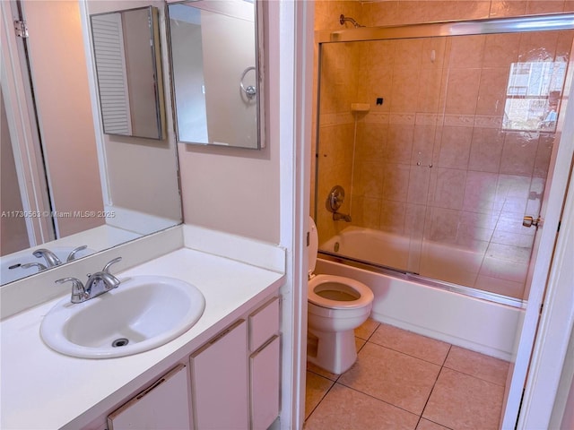 full bathroom featuring vanity, shower / bath combination with glass door, tile patterned floors, and toilet