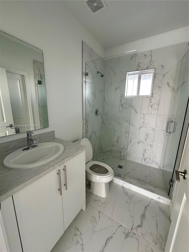 bathroom with toilet, a shower with shower door, and vanity