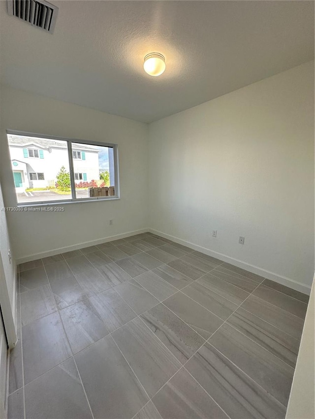 spare room featuring a textured ceiling