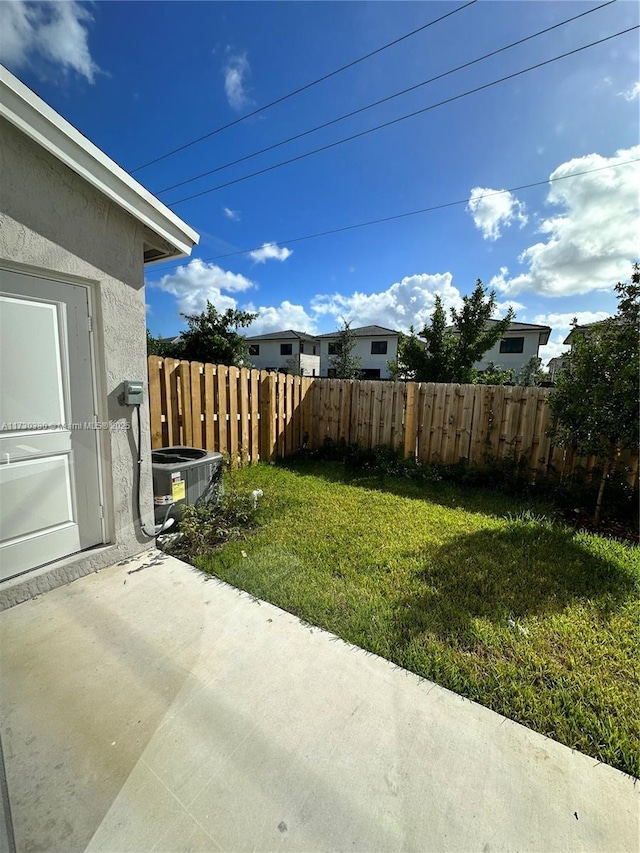 view of yard with a patio and central AC unit