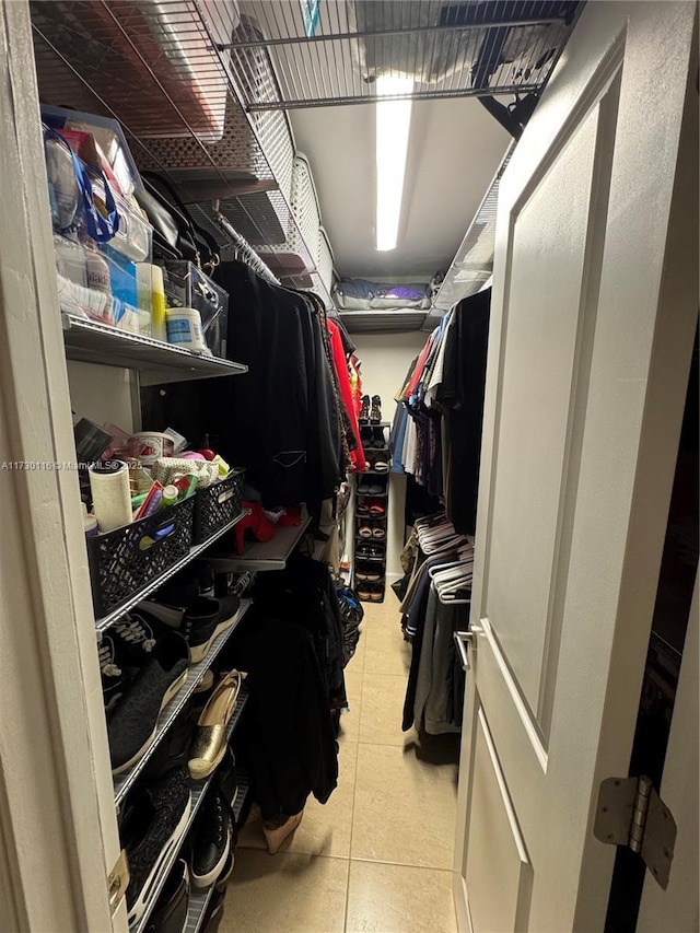 spacious closet with light tile patterned floors