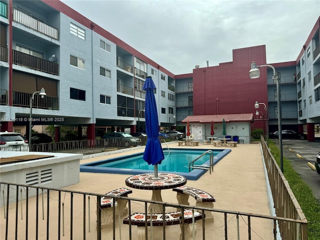 view of swimming pool featuring a patio area