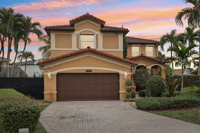 mediterranean / spanish house with a garage