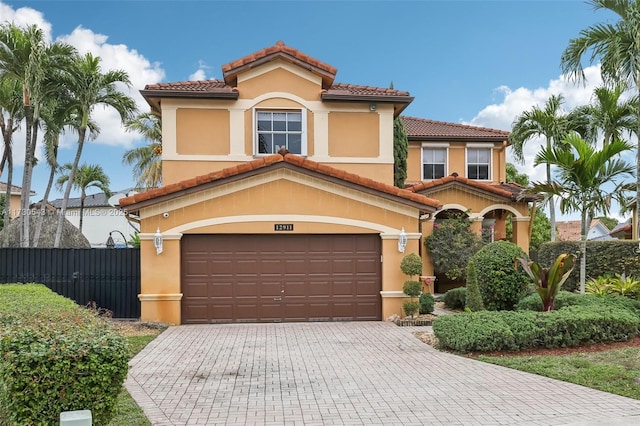 mediterranean / spanish home featuring a garage