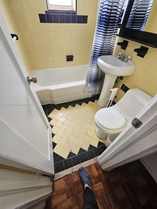 full bathroom with toilet, tasteful backsplash, tile walls, shower / bathtub combination, and vanity