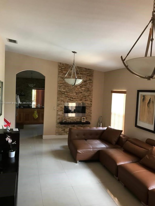 living room featuring light tile patterned floors and lofted ceiling