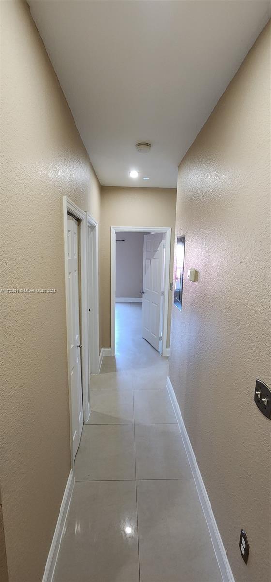 hallway with light tile patterned floors