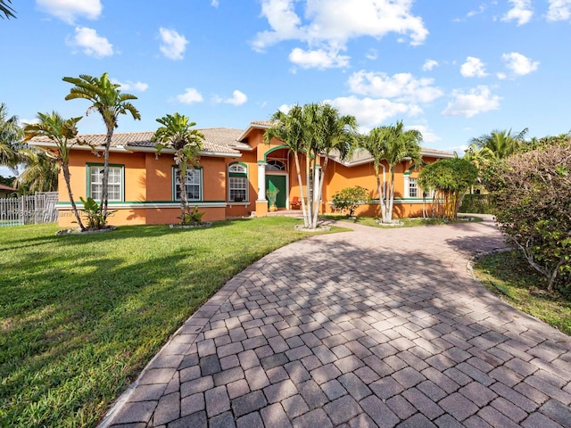 ranch-style home featuring a front yard