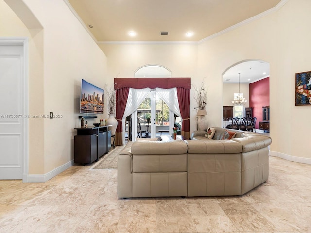 living room with an inviting chandelier and crown molding