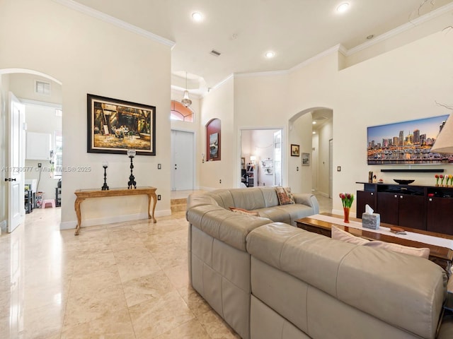 living room with a towering ceiling and ornamental molding