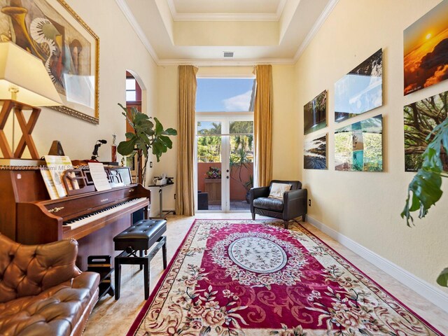 living area with a raised ceiling, ornamental molding, and french doors